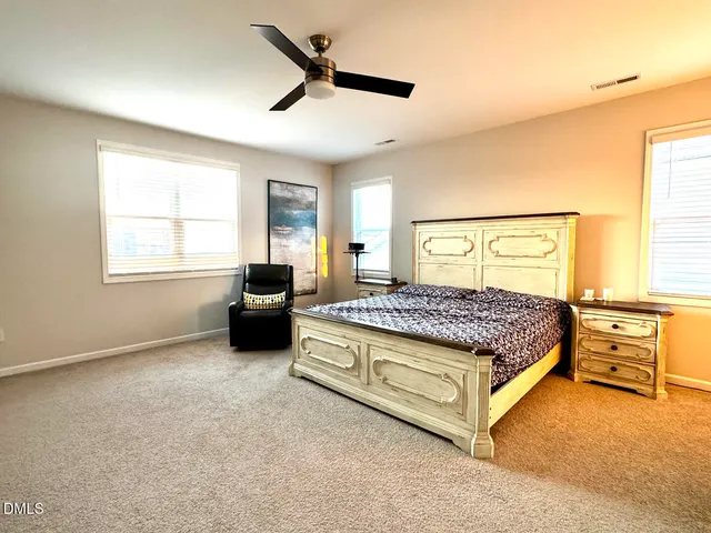 a bathroom with a glass shower door and a window