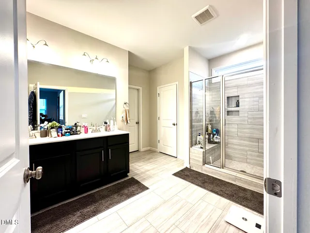 a bedroom with a bed and a refrigerator