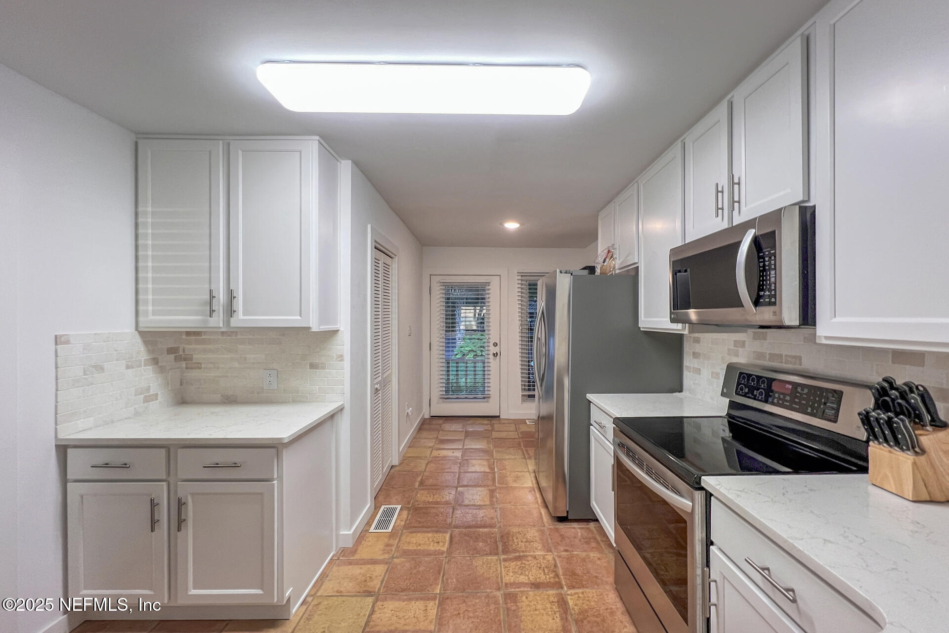 3426 Sea Marsh Road Fernandina Beach, FL 32034 - Photo 15 of 39 a kitchen with stainless steel appliances granite countertop a sink and a stove