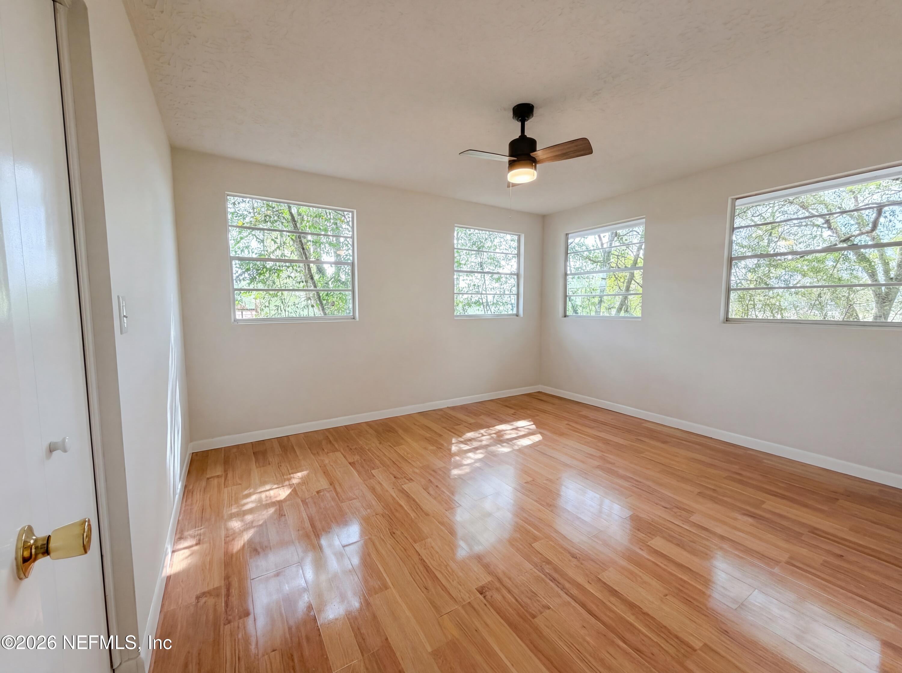 6917 Gatorbone Road Keystone Heights, FL 32656 - Photo 13 of 24 a view of empty room with wooden floor and fan