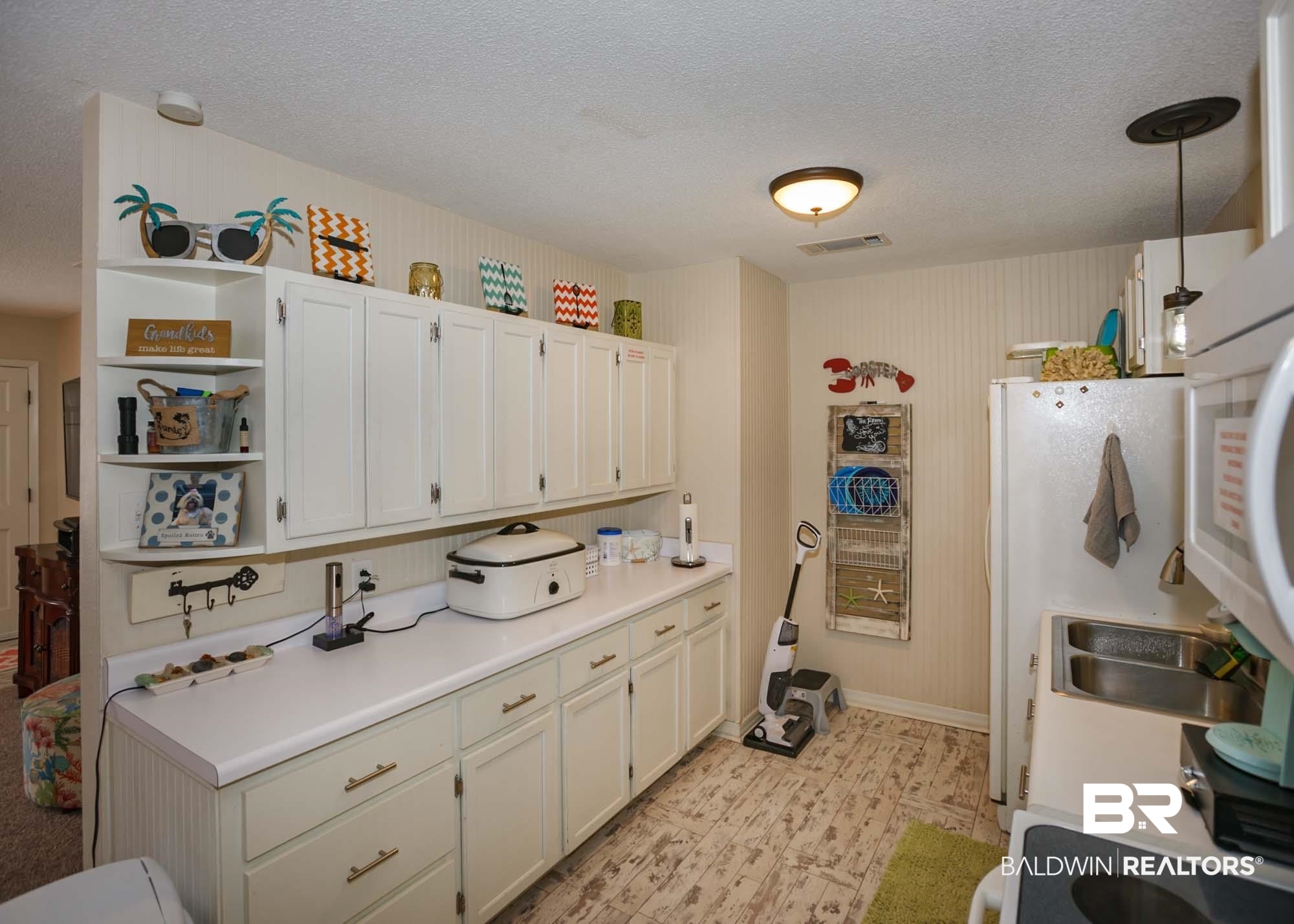 18753 County Road 12 Foley, AL 36535 - Photo 10 of 39 Kitchen with white cabinets, decorative light fixtures, white fridge, and a textured ceiling