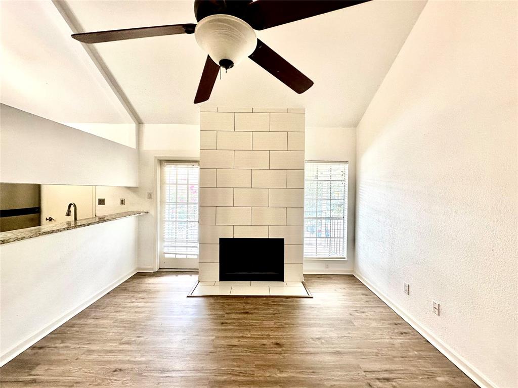 5981 Arapaho Road, Unit 1002 Dallas, TX 75248 - Photo 12 of 16 a view of empty room with wooden floor and fan