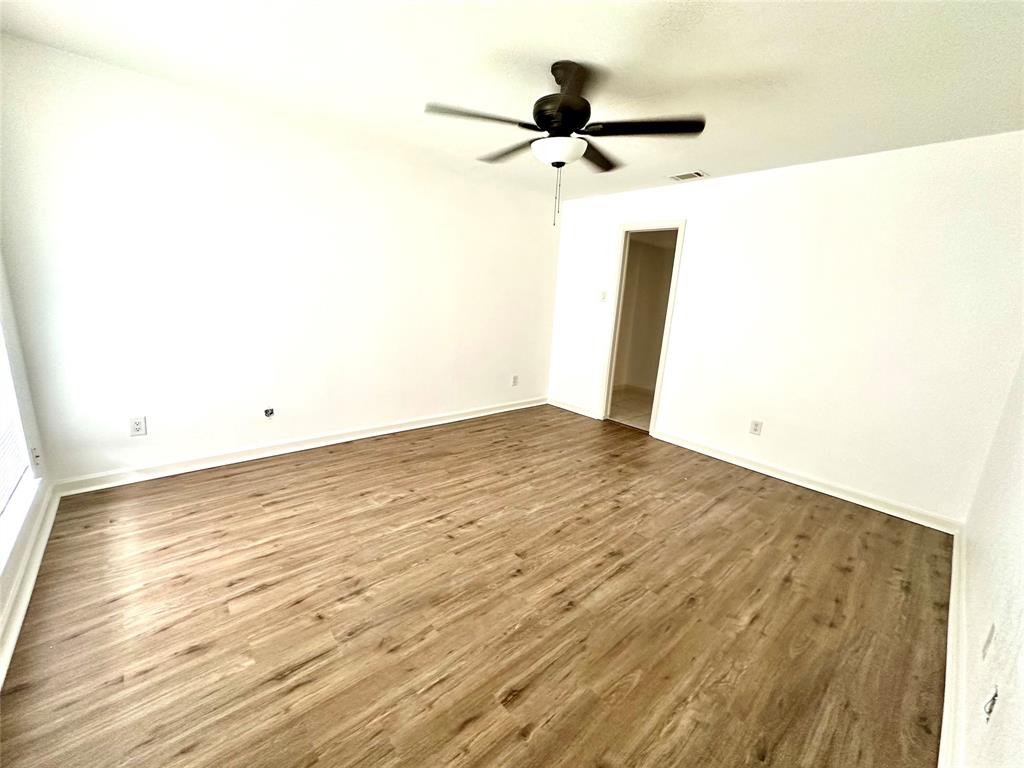 5981 Arapaho Road, Unit 1002 Dallas, TX 75248 - Photo 13 of 16 a view of a room with wooden floor