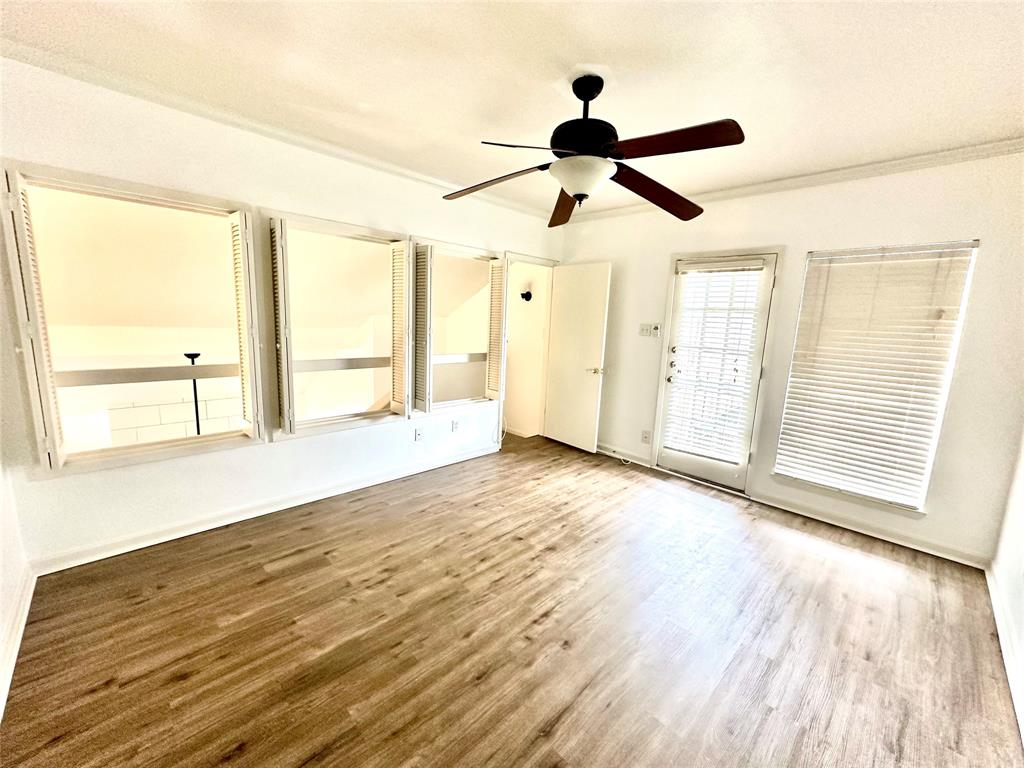 5981 Arapaho Road, Unit 1002 Dallas, TX 75248 - Photo 15 of 16 wooden floor in an empty room with a window