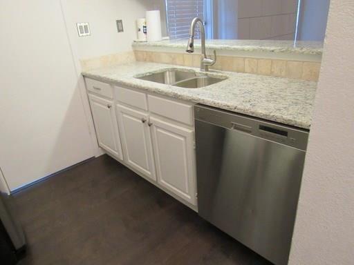 5981 Arapaho Road, Unit 1002 Dallas, TX 75248 - Photo 4 of 16 a kitchen with a sink and cabinets