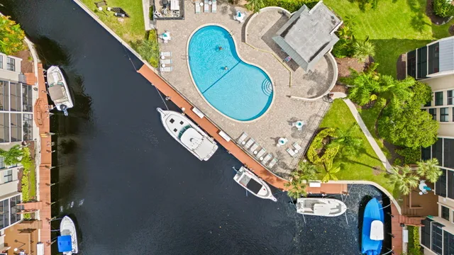 an aerial view of a house with a yard basket ball court and outdoor seating