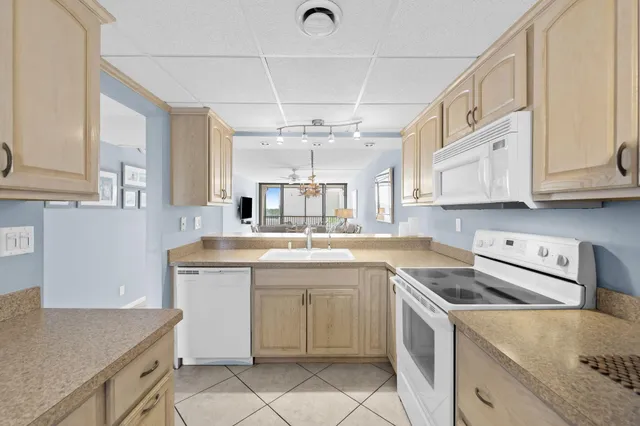 a kitchen with a sink cabinets and window