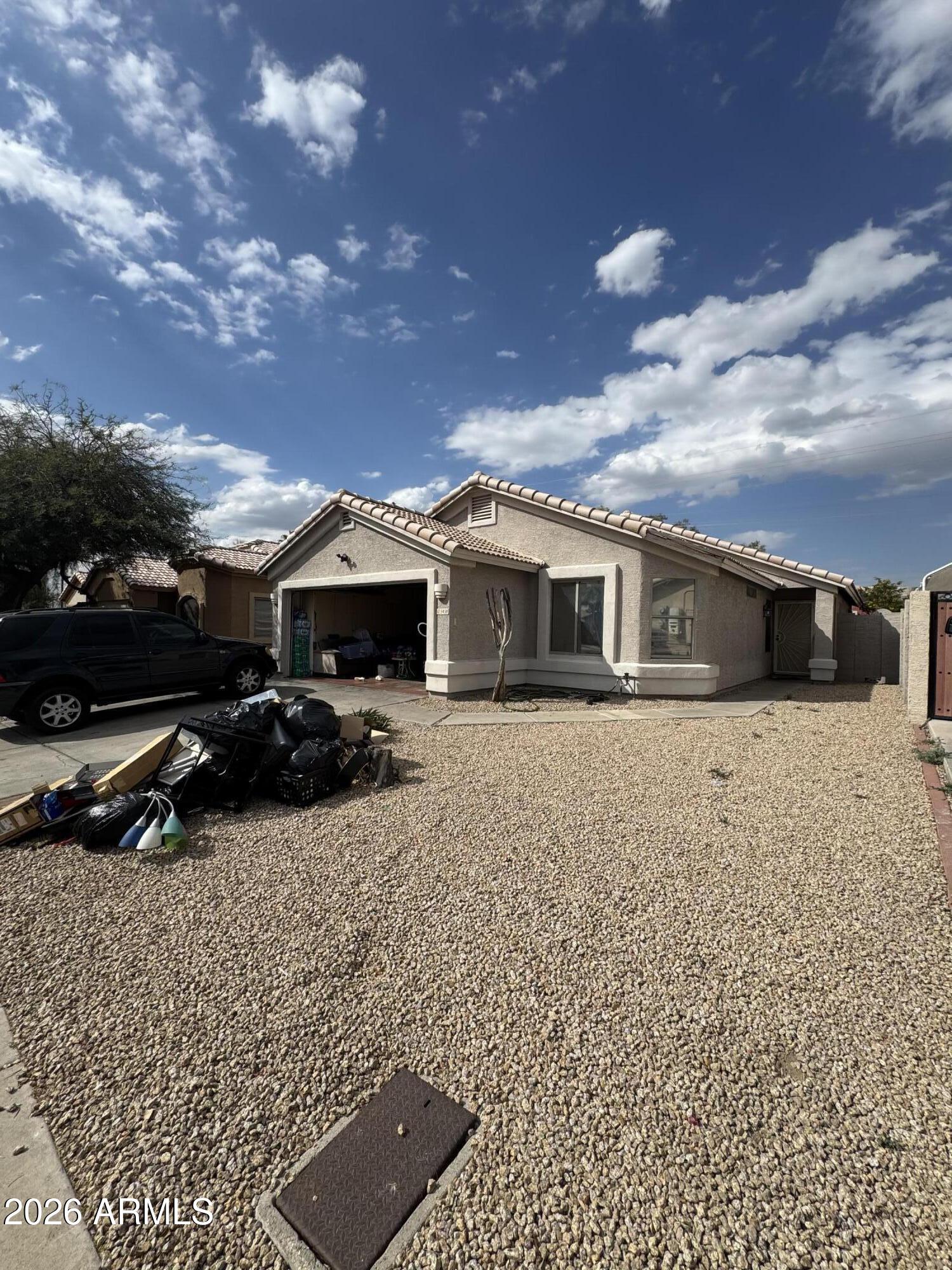5438 West Sands Road Glendale, AZ 85301 - Photo 2 of 7 a view of house with a yard and car parked