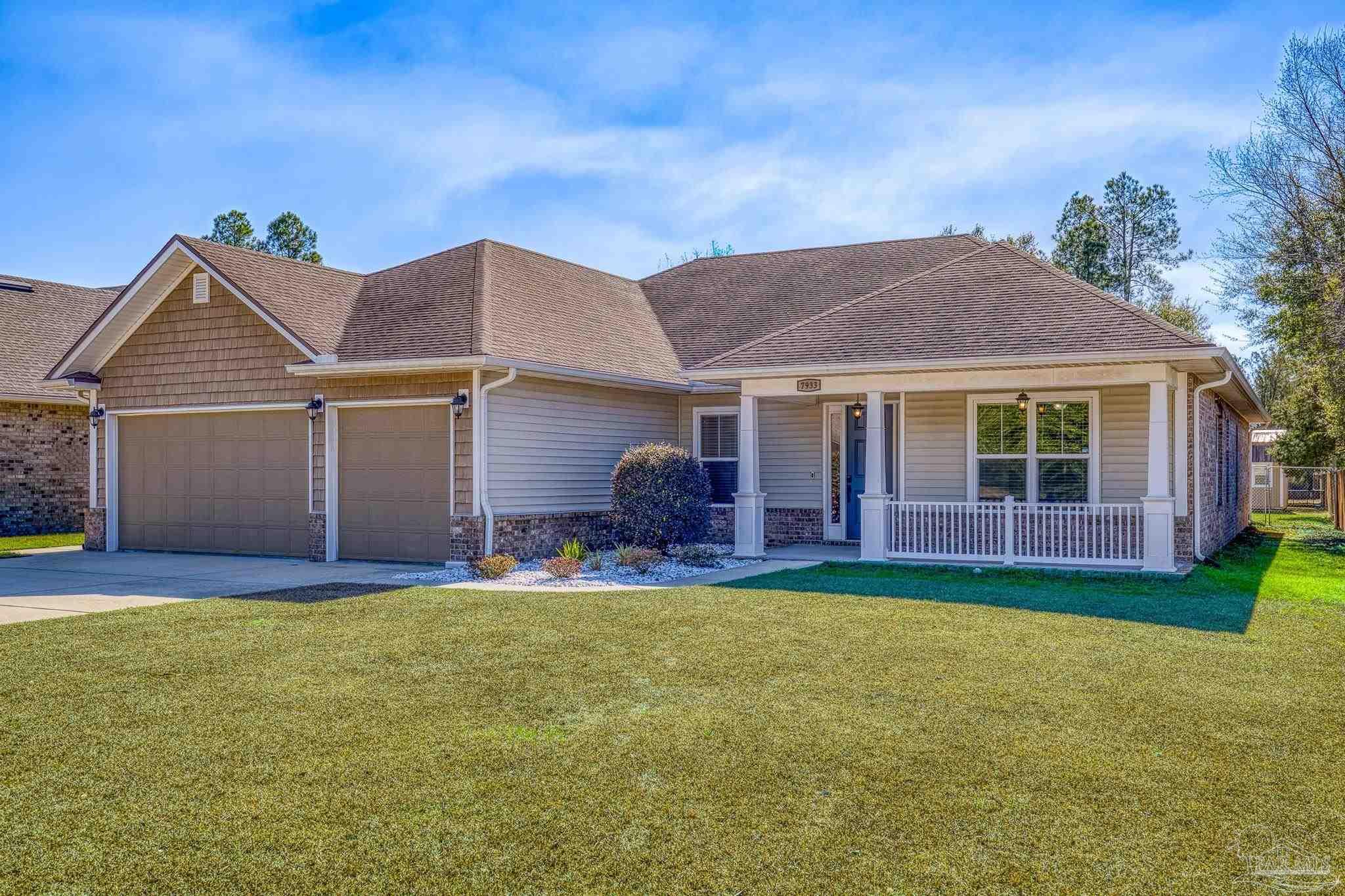 7933 Silver Maple Drive Milton, FL 32583 - Photo 1 of 70 a front view of a house with a garden and porch