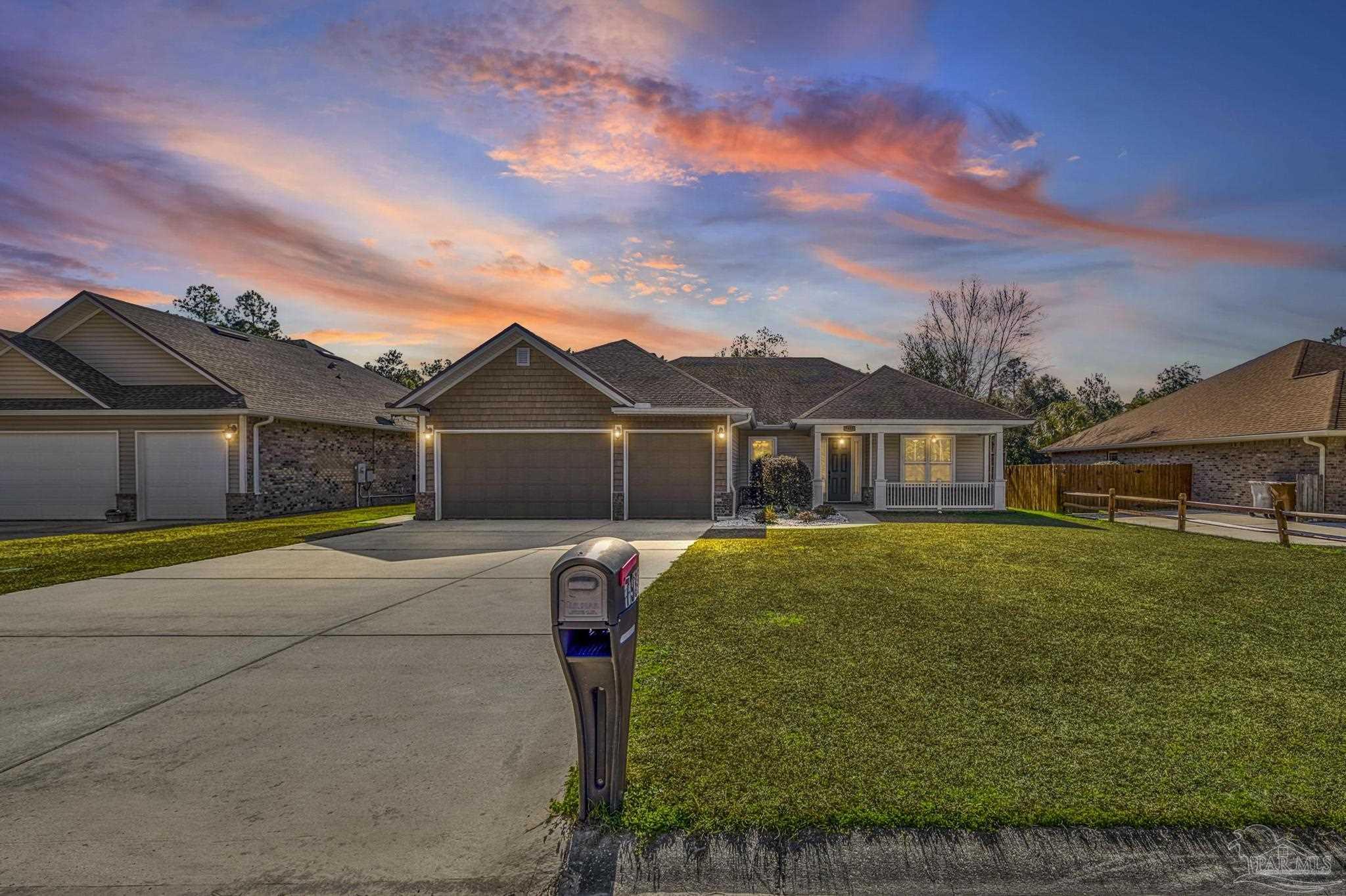 7933 Silver Maple Drive Milton, FL 32583 - Photo 11 of 70 a front view of a house with garden