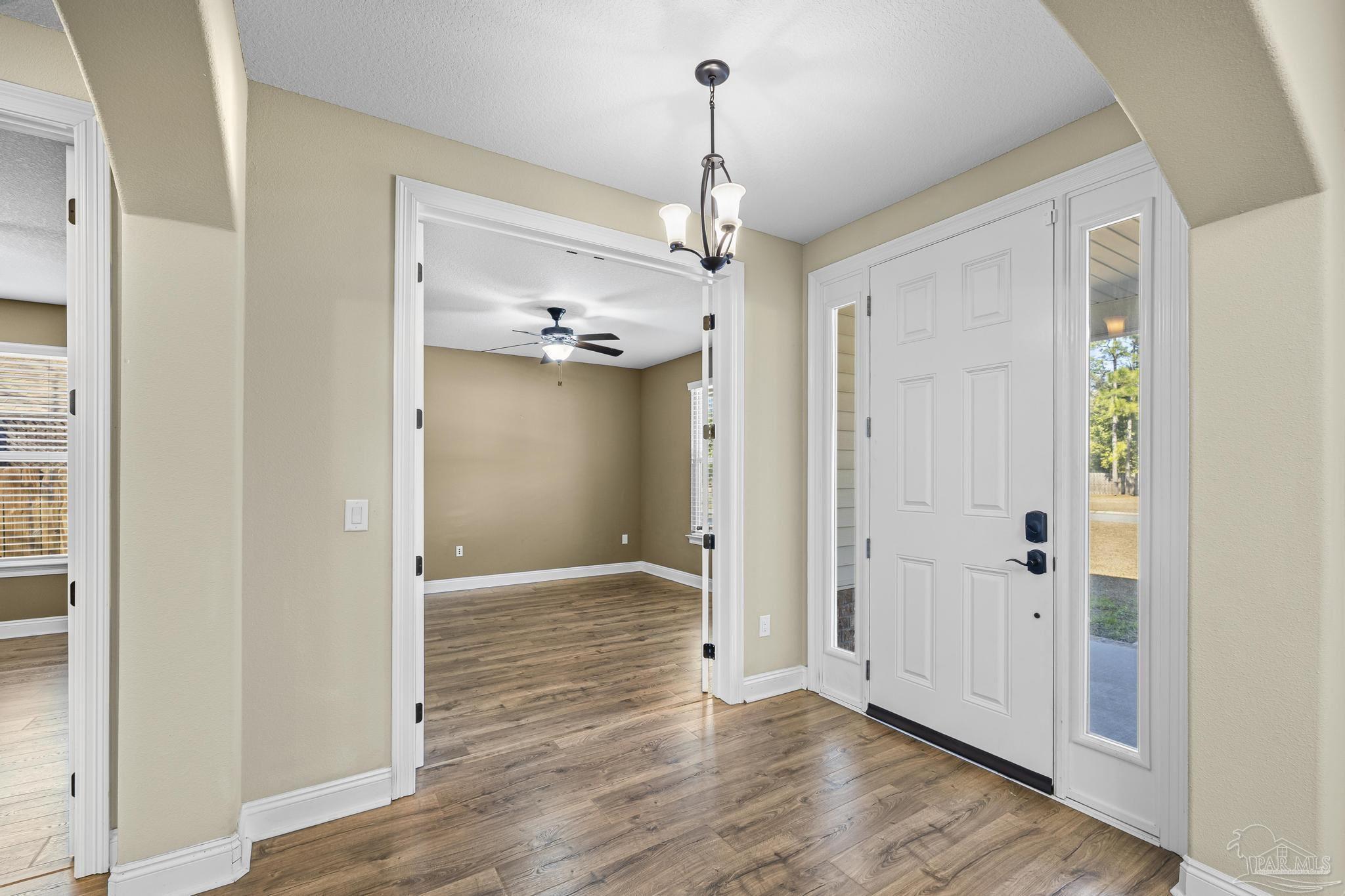 7933 Silver Maple Drive Milton, FL 32583 - Photo 15 of 70 a view of a chandelier in an empty room