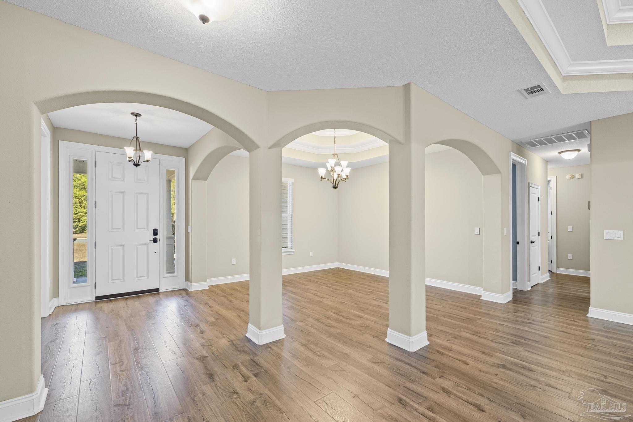 7933 Silver Maple Drive Milton, FL 32583 - Photo 17 of 70 a view of empty room with wooden floor