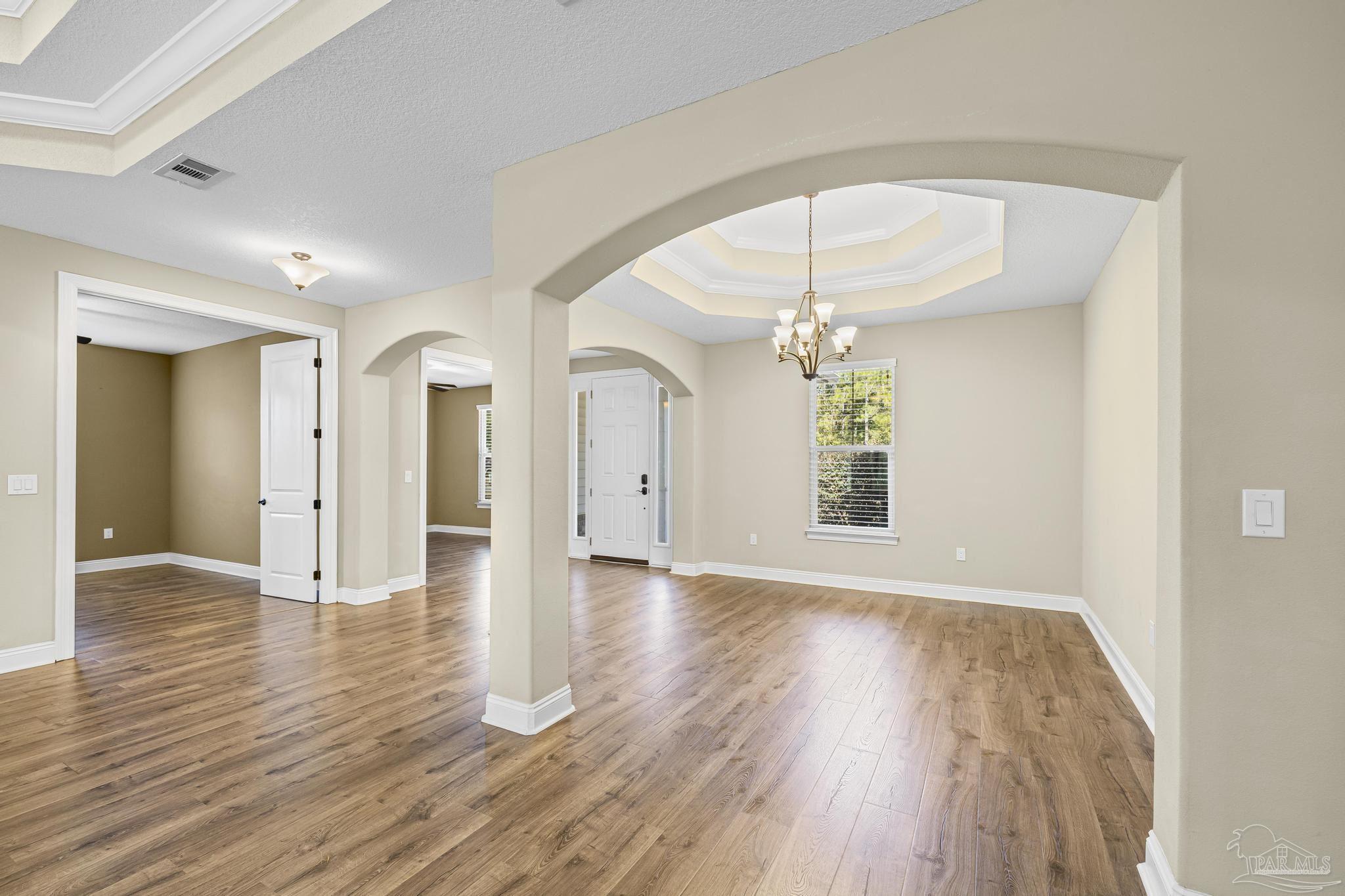 7933 Silver Maple Drive Milton, FL 32583 - Photo 18 of 70 a view of an empty room with wooden floor and a window