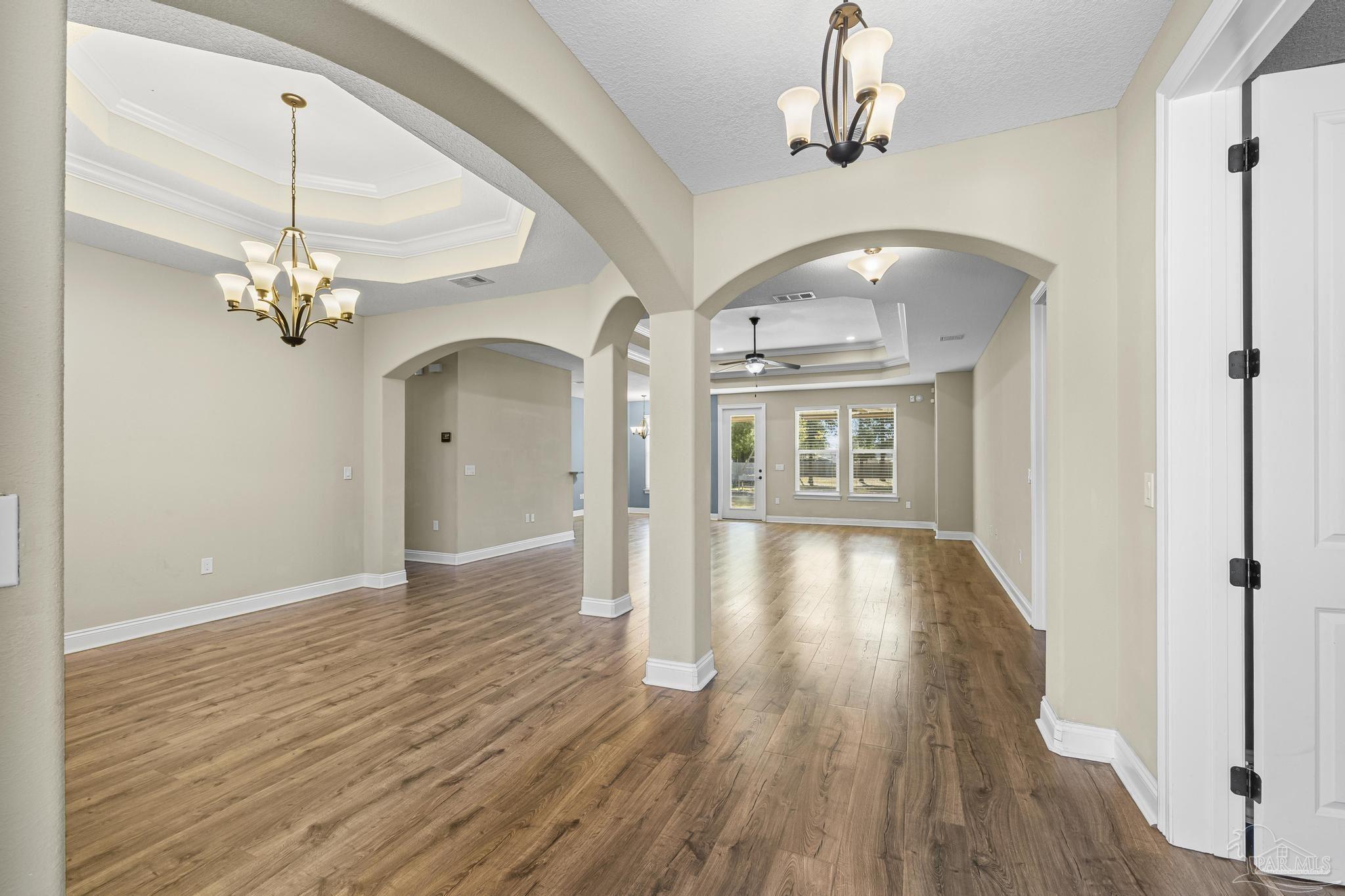 7933 Silver Maple Drive Milton, FL 32583 - Photo 19 of 70 a view of a livingroom with wooden floor chandelier