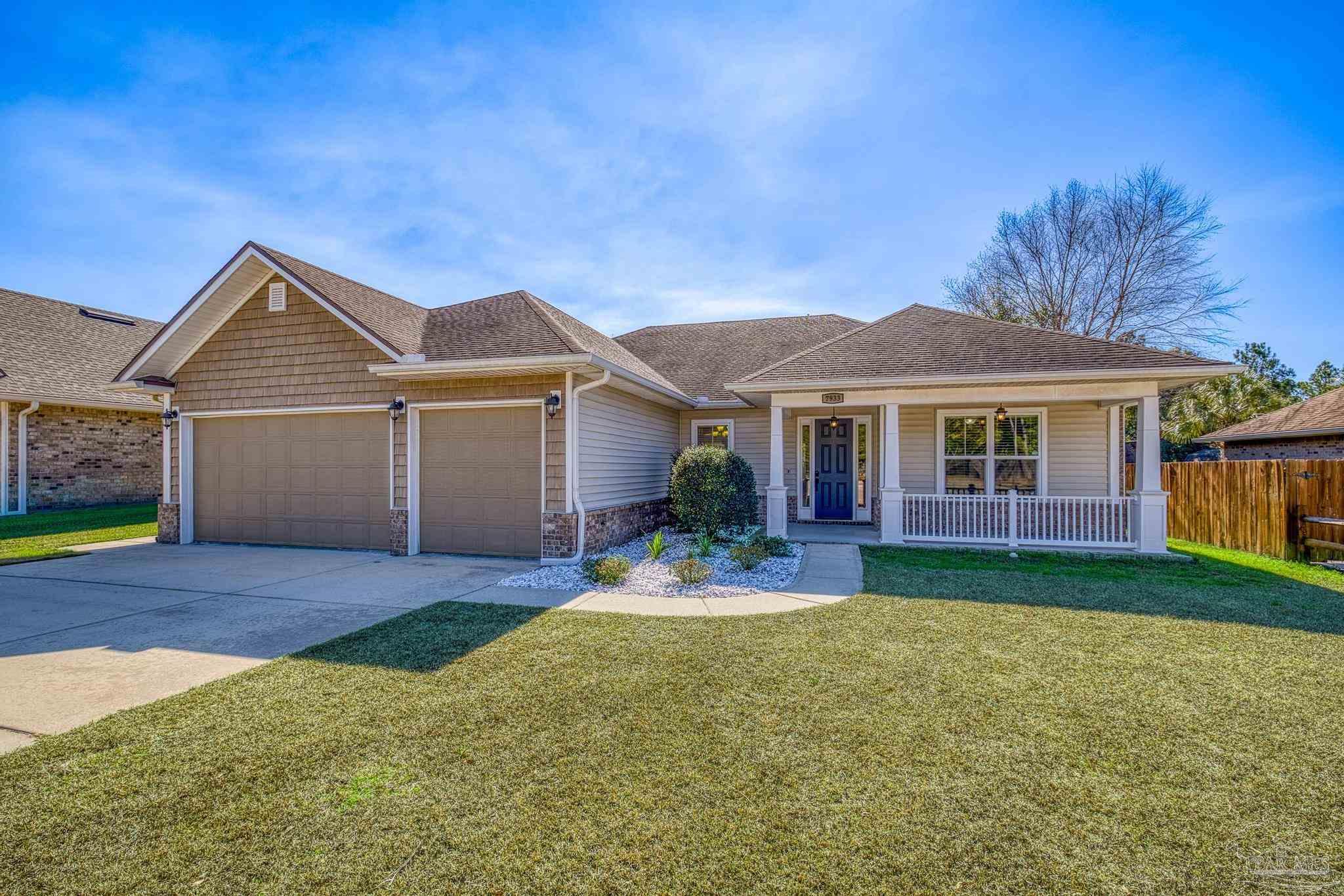 7933 Silver Maple Drive Milton, FL 32583 - Photo 2 of 70 a front view of a house with a yard and porch