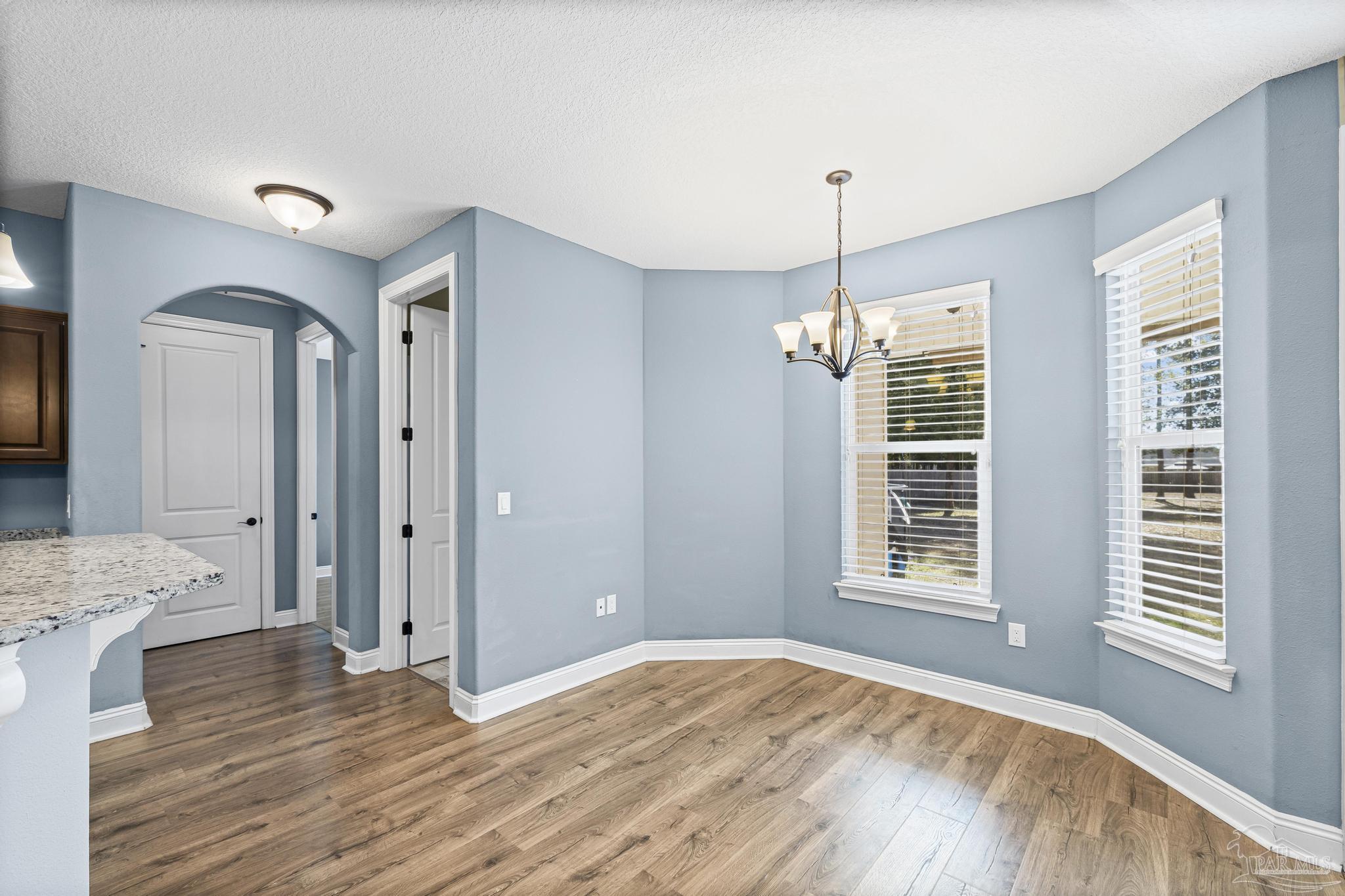 7933 Silver Maple Drive Milton, FL 32583 - Photo 25 of 70 a view of empty room with window and wooden floor