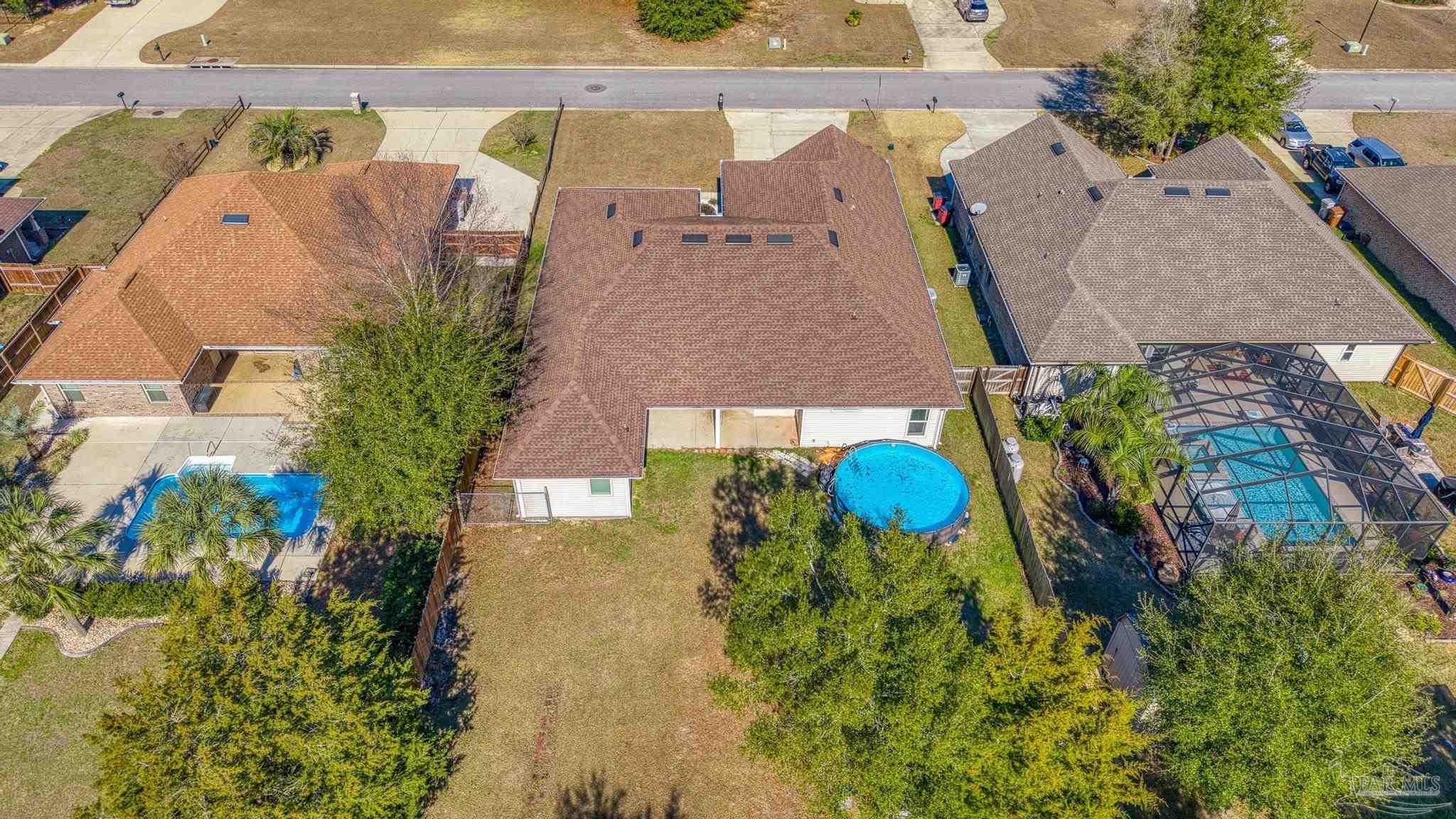 7933 Silver Maple Drive Milton, FL 32583 - Photo 3 of 70 an aerial view of a house with a yard and a large trees
