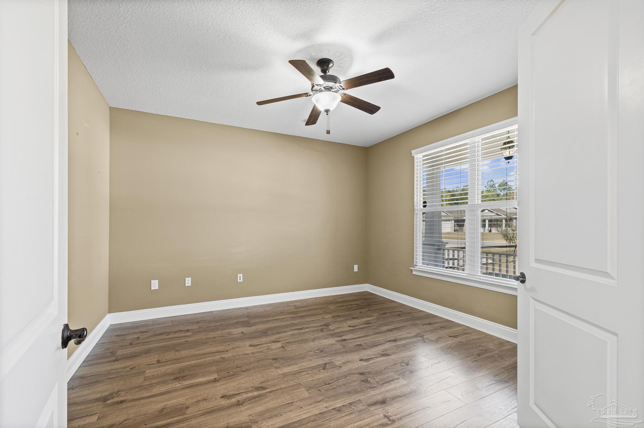 7933 Silver Maple Drive Milton, FL 32583 - Photo 32 of 70 a view of an empty room with wooden floor and a window