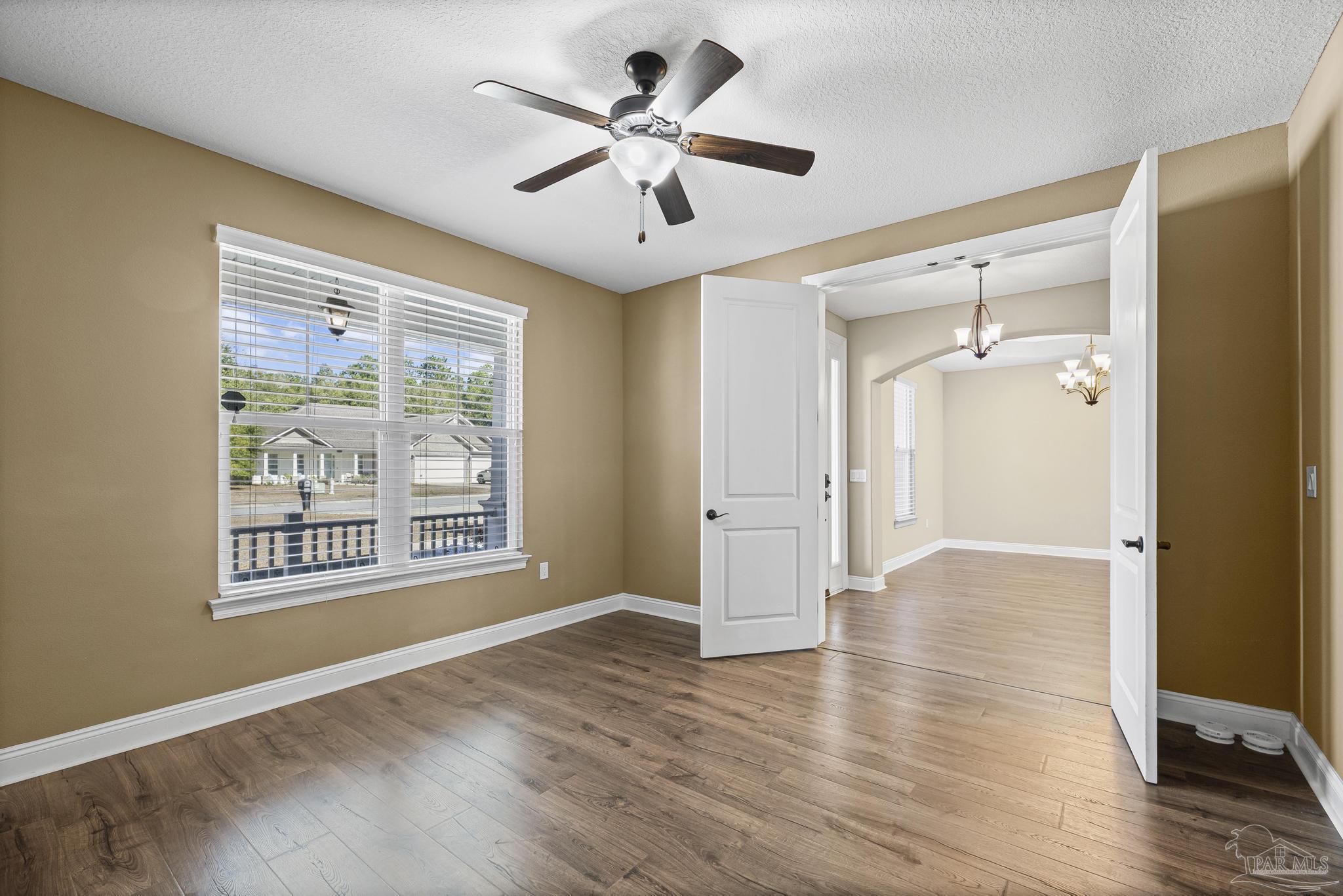 7933 Silver Maple Drive Milton, FL 32583 - Photo 33 of 70 a view of an empty room with a window and wooden floor