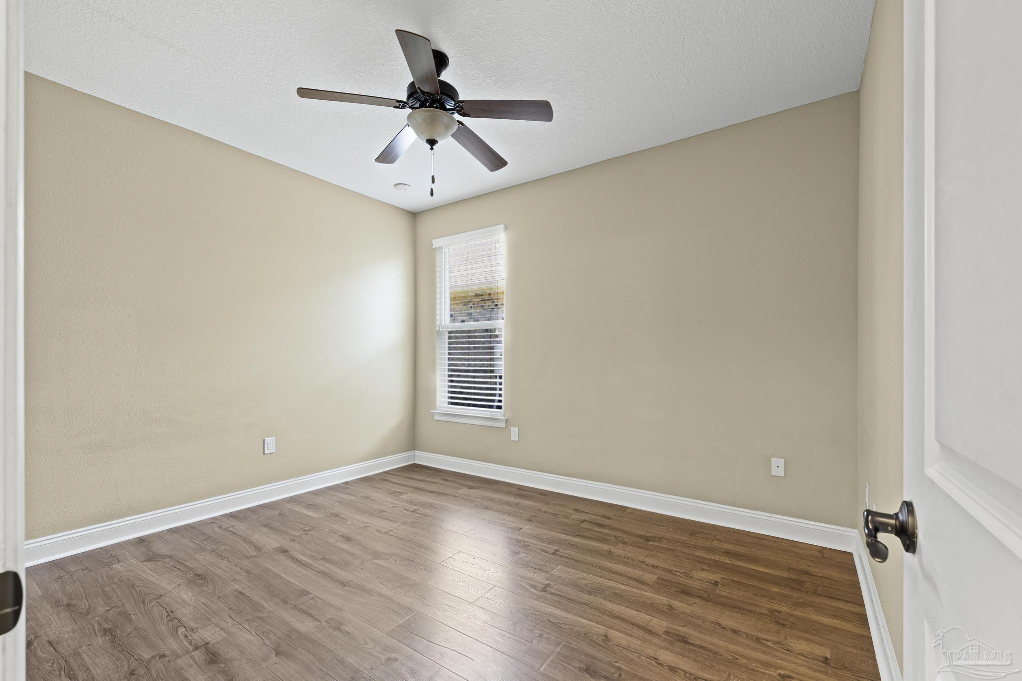 7933 Silver Maple Drive Milton, FL 32583 - Photo 41 of 70 wooden floor in an empty room with a window