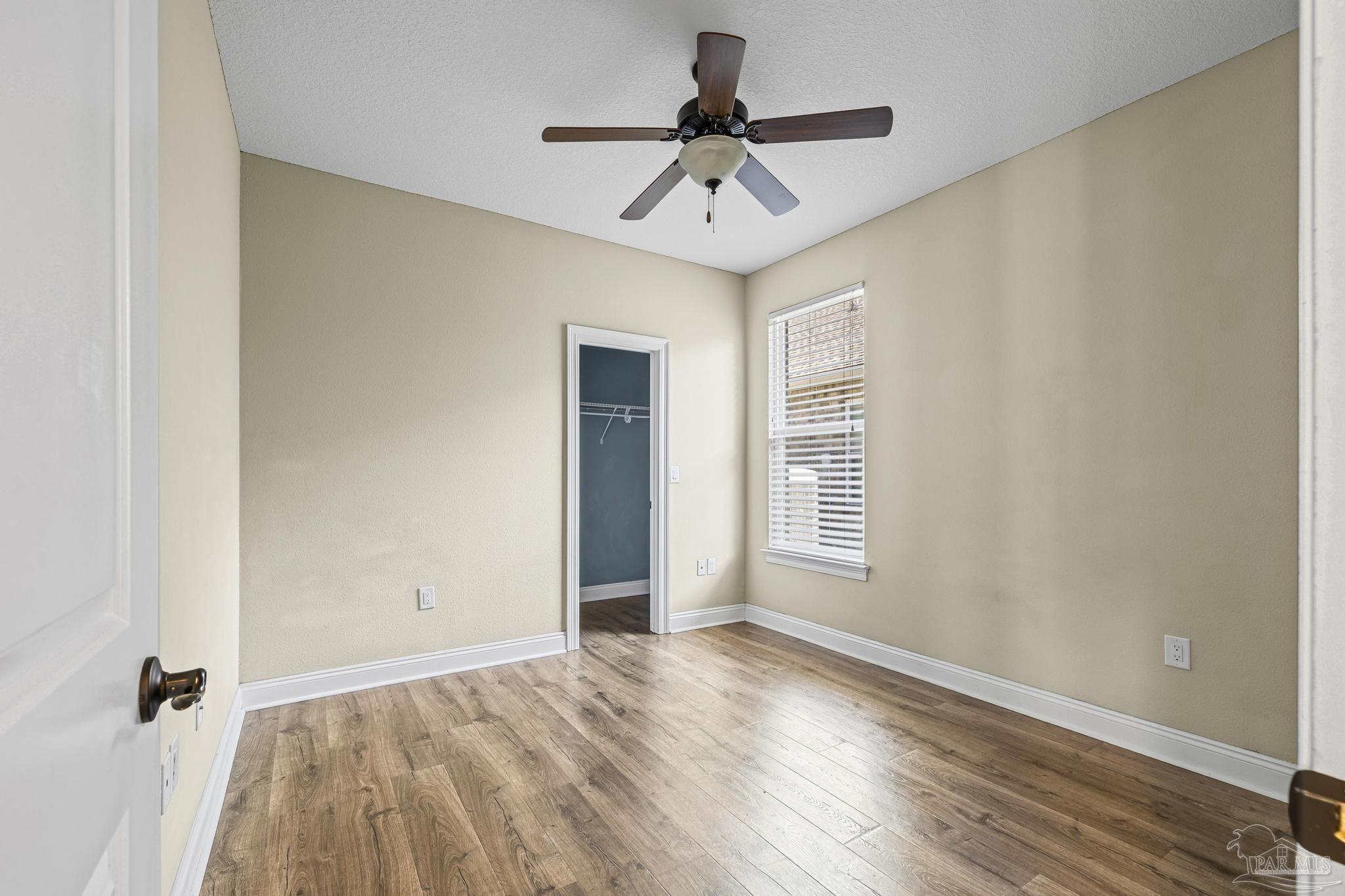7933 Silver Maple Drive Milton, FL 32583 - Photo 46 of 70 wooden floor in an empty room with a window