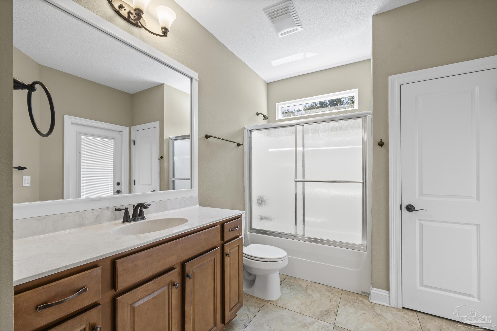7933 Silver Maple Drive Milton, FL 32583 - Photo 49 of 70 a spacious bathroom with a double vanity sink mirror and toilet