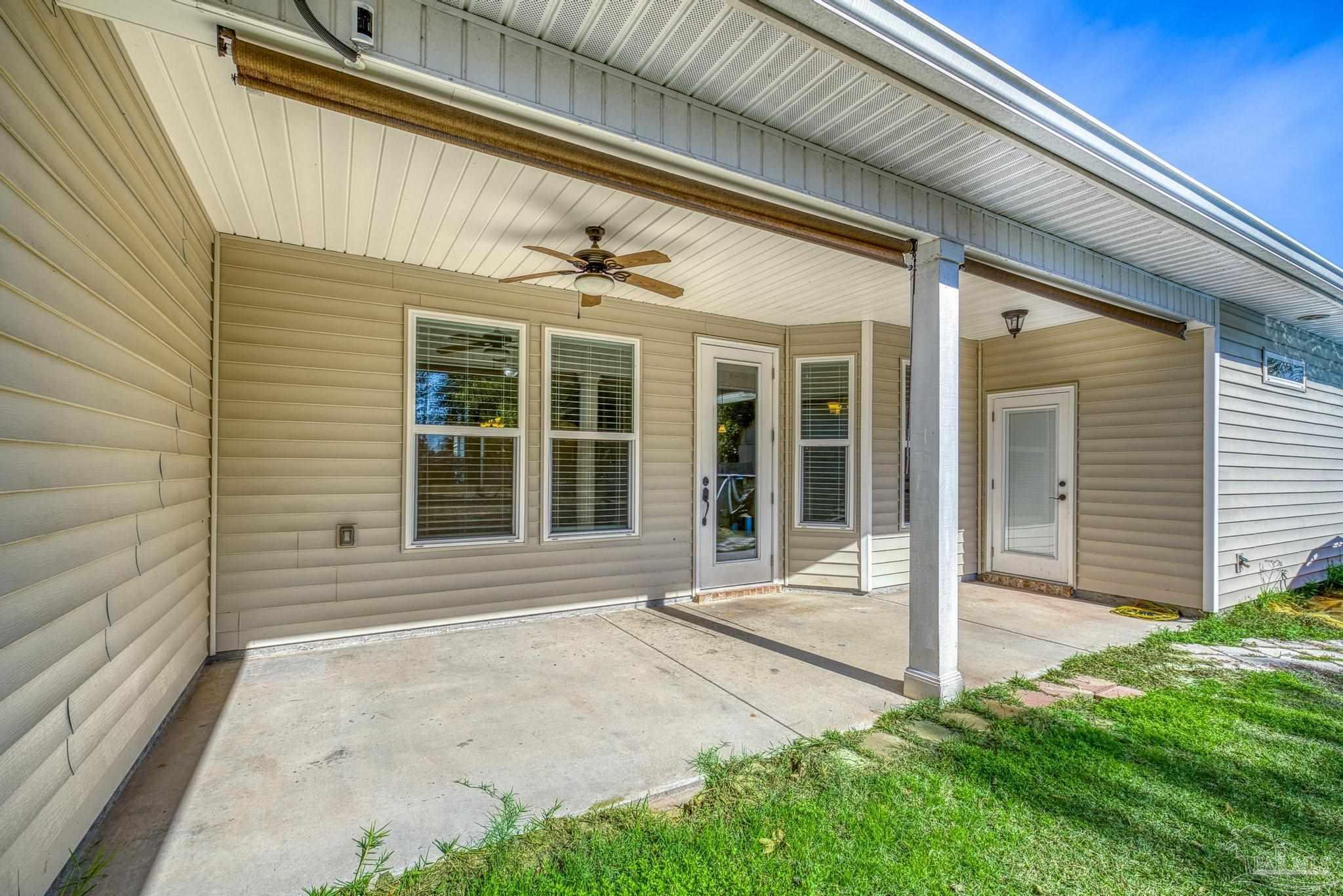 7933 Silver Maple Drive Milton, FL 32583 - Photo 51 of 70 a front view of a house with a yard