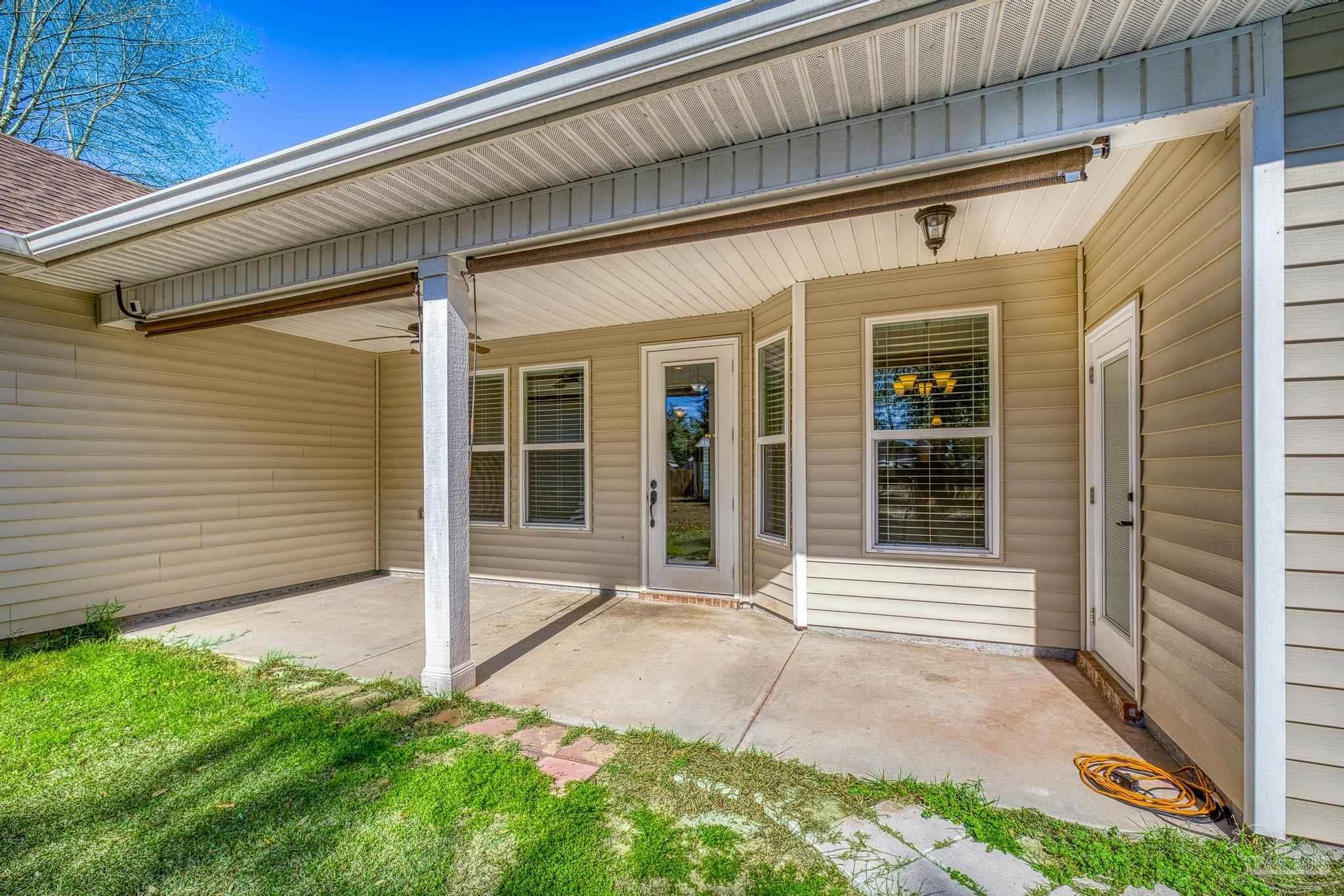 7933 Silver Maple Drive Milton, FL 32583 - Photo 52 of 70 a front view of a house with a yard