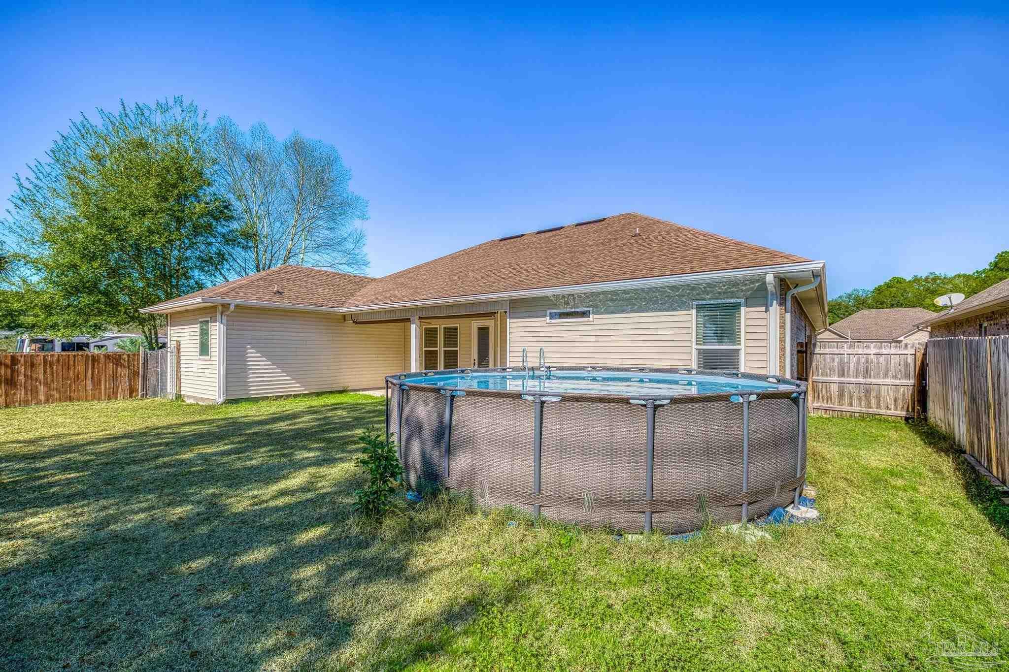 7933 Silver Maple Drive Milton, FL 32583 - Photo 54 of 70 a house view with a garden space