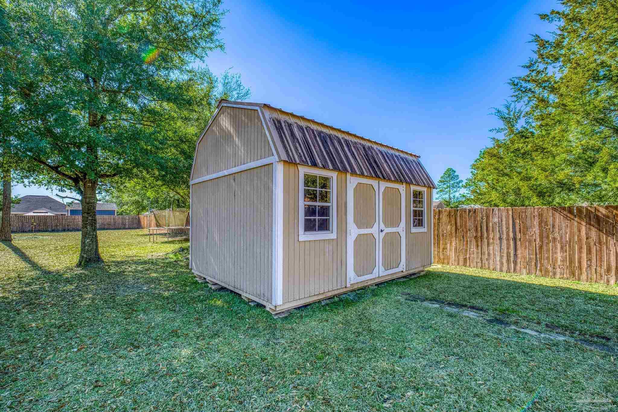 7933 Silver Maple Drive Milton, FL 32583 - Photo 64 of 70 a view of backyard with deck and garden