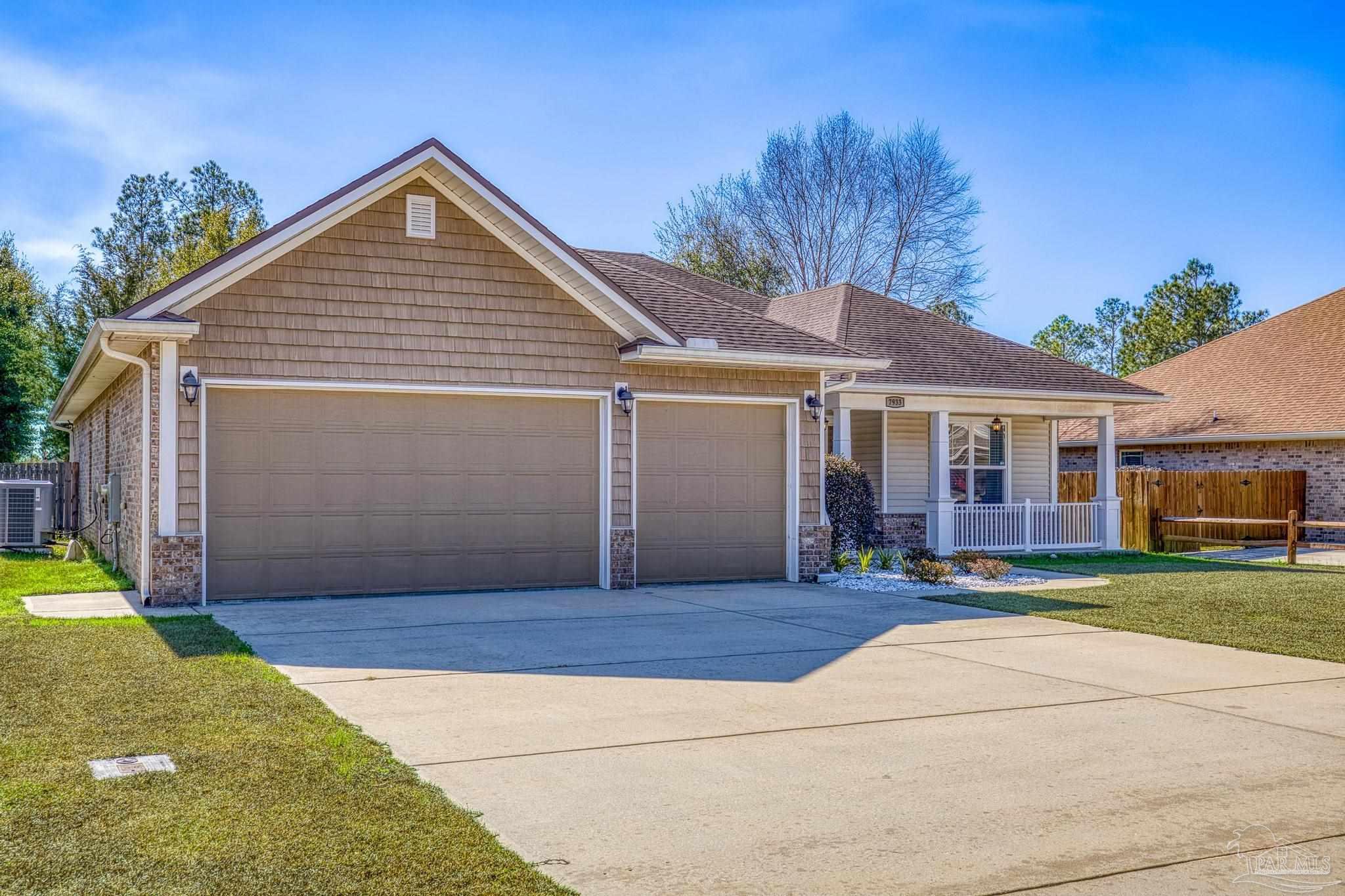 7933 Silver Maple Drive Milton, FL 32583 - Photo 10 of 70 a front view of a house with a yard and garage