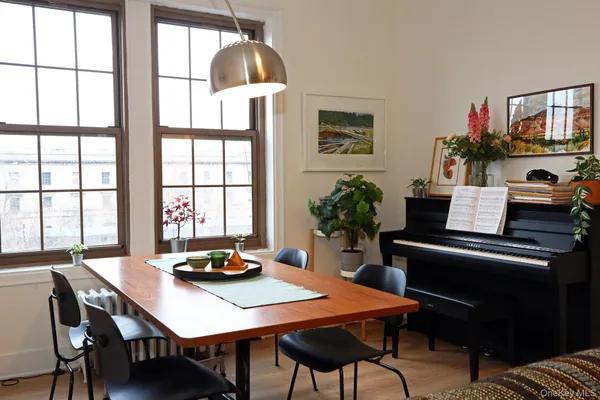a view of a dining room with furniture and window