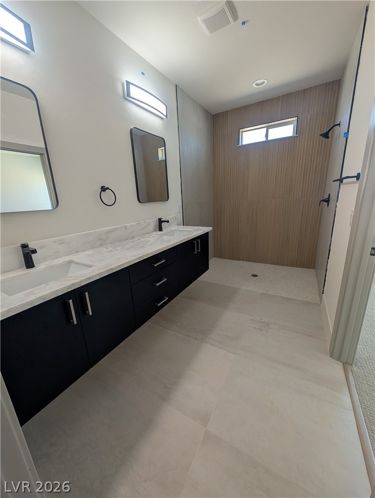 4670 Medicine Man Road Pahrump, NV 89048 - Photo 18 of 36 A well-appointed primary bathroom showcases a floating double vanity with a spacious walk-in shower.