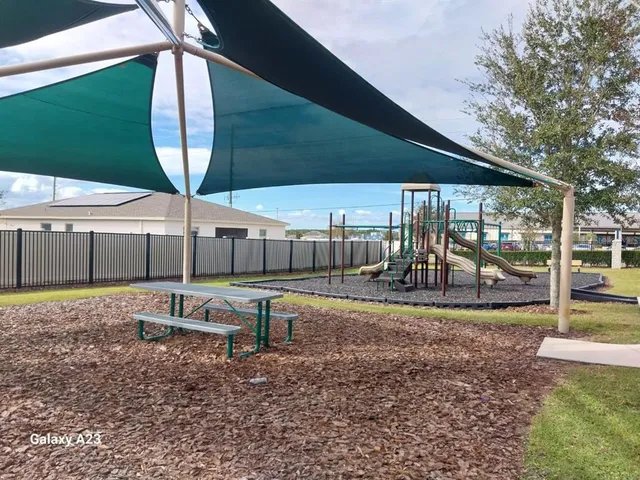 a view of a backyard with sitting area