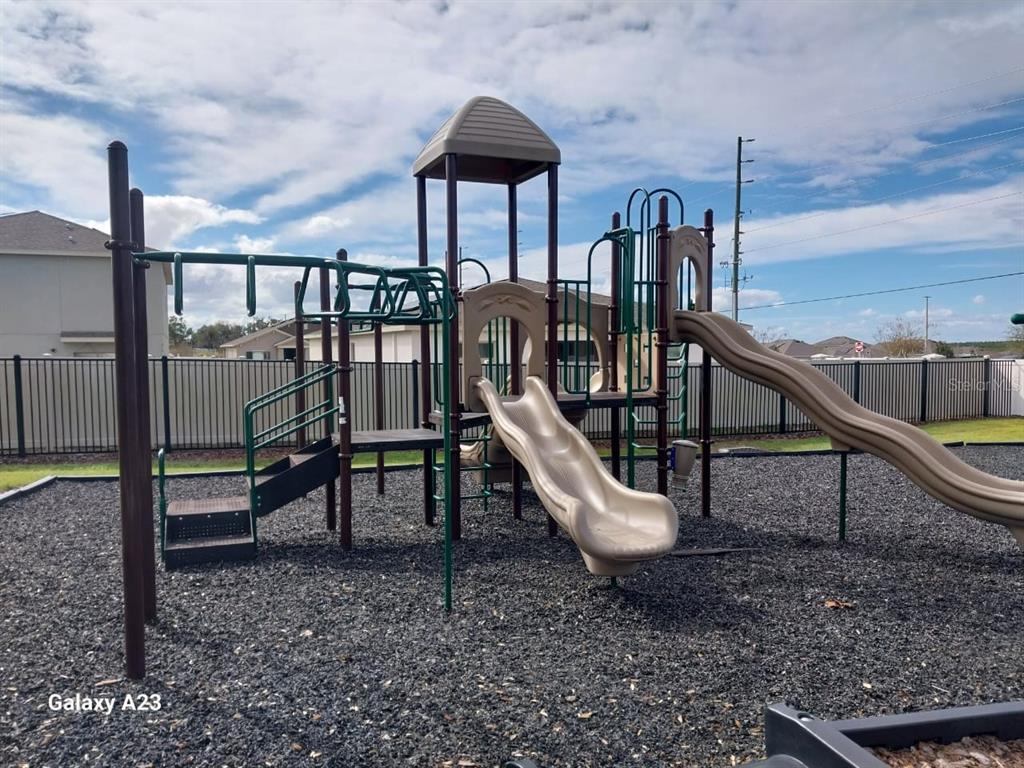 1176 Citrus Landings Boulevard Davenport, FL 33837 - Photo 15 of 15 a view of a wooden deck and a backyard