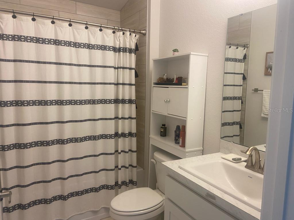 1176 Citrus Landings Boulevard Davenport, FL 33837 - Photo 7 of 15 a bathroom with a sink toilet and shower