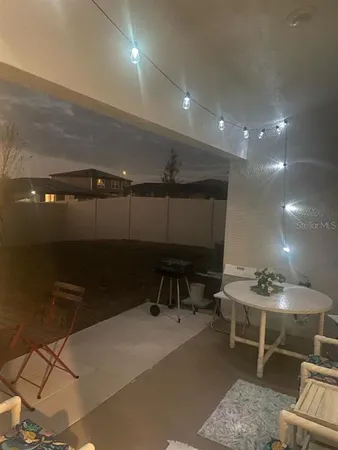 a room with furniture a rug and white walls