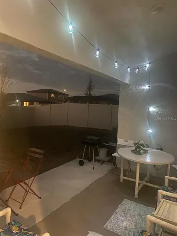 a room with furniture a rug and white walls