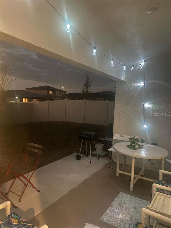 1176 Citrus Landings Boulevard Davenport, FL 33837 - Photo 8 of 15 a room with furniture a rug and white walls