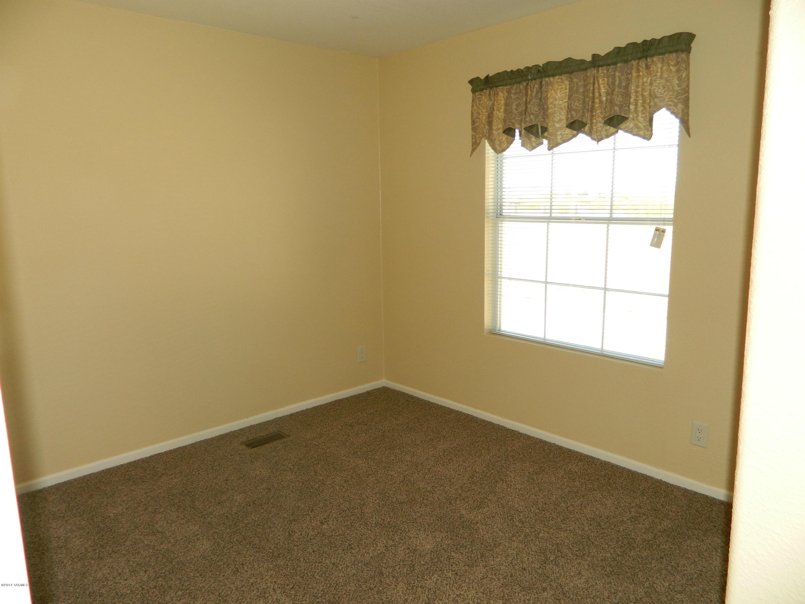 5204 North Puma Road Marana, AZ 85653 - Photo 19 of 36 an empty room with a window