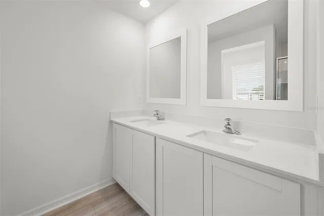 a bathroom with a shower and a glass door