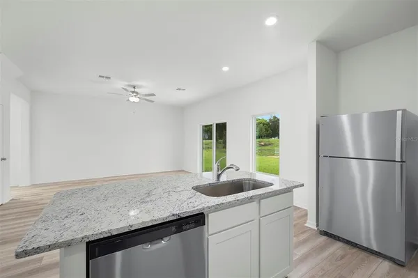 a kitchen with a sink and refrigerator