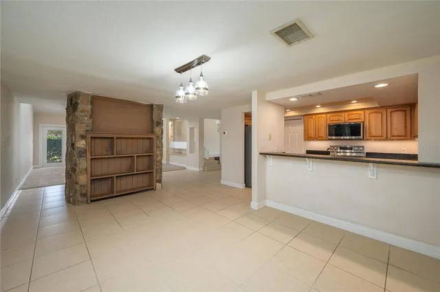a view of kitchen with furniture and refrigerator