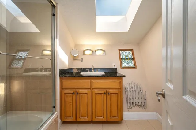 a bathroom with a tub sink and mirror