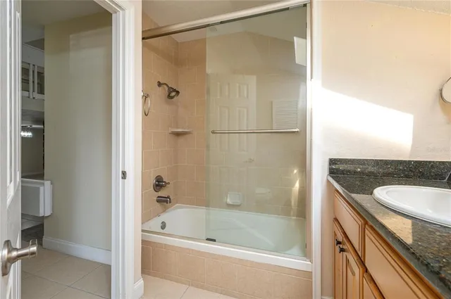 a bath tub sitting next to a bathroom sink