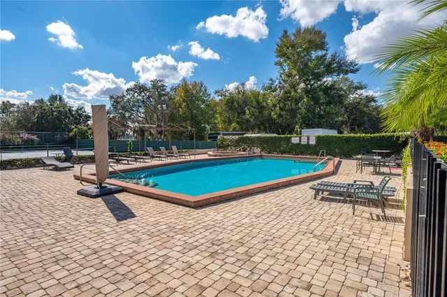 a swimming pool with outdoor seating