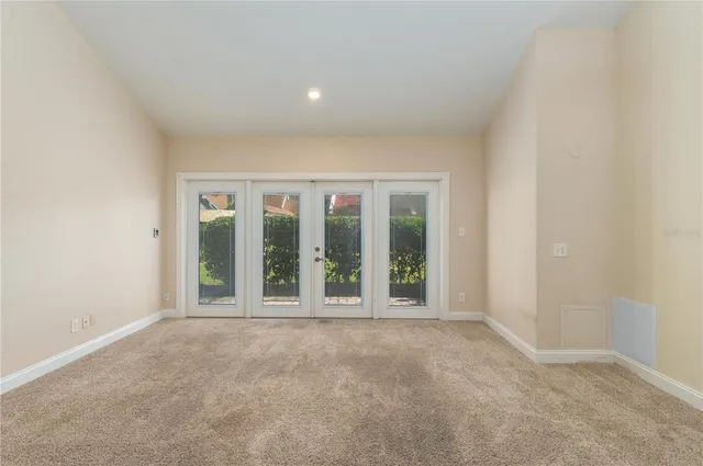 a view of an empty room with glass door and balcony