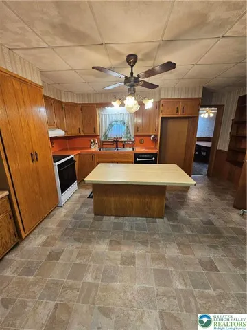 a living room with patio furniture and a flat screen tv