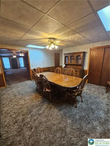 a room with furniture and a air conditioner vent