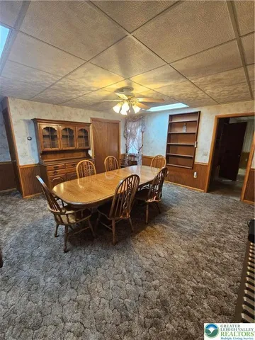 a view of a dining room with furniture window and outside view